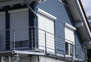 Nahaufnahme von einem blauen Haus mit heruntergelassenen Rolläden